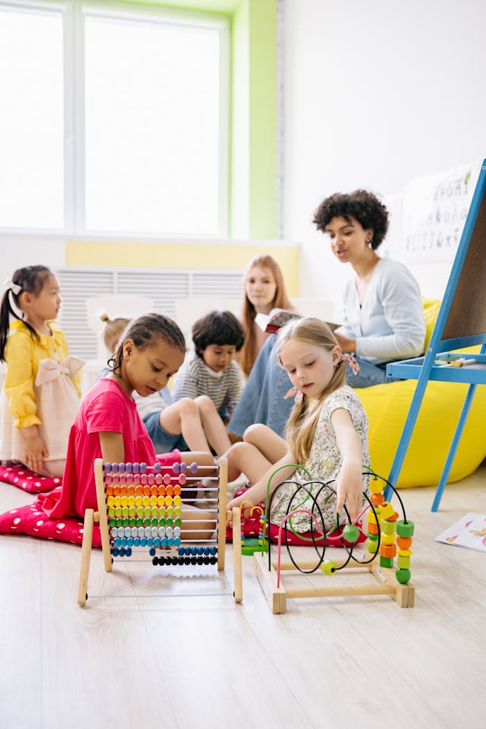 Home Preschool children with a teacher engaging in educational activities in a bright classroom.